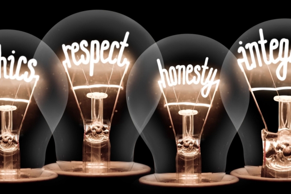 Illustration of four lightbulbs with the words ethics, respect, honesty and integrity spelt out in the filaments